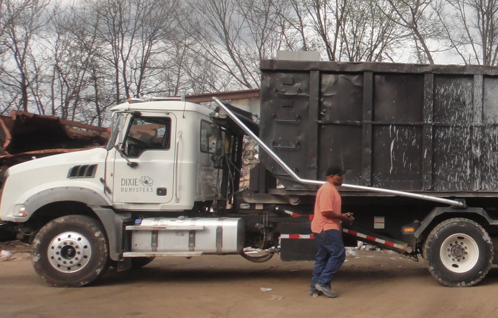 roll off dumpster coming off truck
